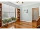Cozy bedroom featuring light hardwood floors, a built-in bookcase, and a large window with serene natural light at 601 Laurel Xing, Canton, GA 30114