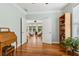 Bedroom featuring light hardwood floors, built-in bookcase, and open french doors to another room with rocking chairs at 601 Laurel Xing, Canton, GA 30114