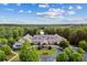 Stunning aerial shot of a clubhouse with lovely landscaping, trees, and circular driveway at 601 Laurel Xing, Canton, GA 30114