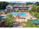 Aerial shot of a large community pool with ample seating, mature trees, and an elegant clubhouse overlooking the refreshing space at 601 Laurel Xing, Canton, GA 30114
