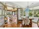Bright dining area featuring hardwood floors, modern light fixture, and access to a screened-in porch at 601 Laurel Xing, Canton, GA 30114