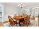 Bright dining room with a wooden table, chandelier, and easy access to other rooms at 601 Laurel Xing, Canton, GA 30114