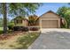 Charming one-story home with manicured lawn, mature trees, and two-car garage at 601 Laurel Xing, Canton, GA 30114