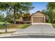 Charming one-story home with manicured lawn, mature trees, and two-car garage at 601 Laurel Xing, Canton, GA 30114