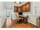 Well lit home office provides a quiet workspace with hardwood floors and custom built-in wall storage with view of the backyard at 601 Laurel Xing, Canton, GA 30114