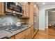 Gourmet kitchen featuring granite countertops, stainless steel appliances, and custom backsplash at 601 Laurel Xing, Canton, GA 30114