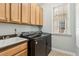 Laundry room features a utility sink, washer/dryer, and plenty of cabinet storage at 601 Laurel Xing, Canton, GA 30114
