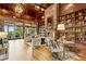 Elegant community lounge with a stone fireplace, a chandelier, comfortable seating, and extensive bookshelves at 601 Laurel Xing, Canton, GA 30114