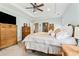 Spacious primary bedroom features tray ceilings, carpet floors and elegant wooden furniture for a classic touch at 601 Laurel Xing, Canton, GA 30114