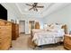 Spacious primary bedroom features tray ceilings, carpet floors, and elegant wooden furniture for a classic touch at 601 Laurel Xing, Canton, GA 30114