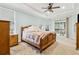 Spacious primary bedroom features tray ceilings, carpet floors, a sitting area and private access to the back patio at 601 Laurel Xing, Canton, GA 30114