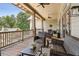 Covered outdoor patio with wicker furniture, ceiling fans and wood decking at 601 Laurel Xing, Canton, GA 30114