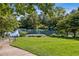 A tranquil pond with a wooden dock surrounded by mature trees and well-manicured lawn at 601 Laurel Xing, Canton, GA 30114