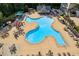 Expansive community pool featuring a unique design, lounging areas, and seating under umbrellas, perfect for relaxation at 601 Laurel Xing, Canton, GA 30114