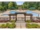 Aerial view of community pool, lounge chairs, umbrellas and trellis at 601 Laurel Xing, Canton, GA 30114