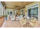 Spacious screened-in porch with wicker furniture, a glass-top table, and serene outdoor views at 601 Laurel Xing, Canton, GA 30114