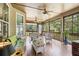Relaxing screened-in porch featuring wicker furniture and ceiling fans, perfect for enjoying the outdoors at 601 Laurel Xing, Canton, GA 30114