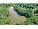 Property aerial view showcasing the lake and wooded community with mature trees at 109 Lake Latimer Ne Cv, Kennesaw, GA 30144