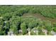 Aerial view featuring the community with lush tree coverage and beautiful lake at 109 Lake Latimer Ne Cv, Kennesaw, GA 30144