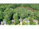 Aerial view of property showing home's location near a serene lake and surrounded by lush trees at 109 Lake Latimer Ne Cv, Kennesaw, GA 30144