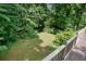 View of the private wooded backyard from the wooden deck at 109 Lake Latimer Ne Cv, Kennesaw, GA 30144
