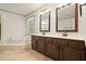 Bathroom featuring tiled floors, a soaking tub with steps, and a double sink vanity at 109 Lake Latimer Ne Cv, Kennesaw, GA 30144