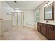 Bathroom featuring tiled floors, a glass shower, a soaking tub, and a single sink vanity at 109 Lake Latimer Ne Cv, Kennesaw, GA 30144