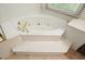 Corner soaking tub with steps offers a relaxing spa-like experience at 109 Lake Latimer Ne Cv, Kennesaw, GA 30144