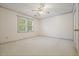 Cozy bedroom featuring a ceiling fan, large window, and a door to the hallway at 109 Lake Latimer Ne Cv, Kennesaw, GA 30144