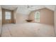 Spacious bedroom with carpet flooring, a ceiling fan, and large windows allowing for plenty of natural light at 109 Lake Latimer Ne Cv, Kennesaw, GA 30144