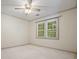Bedroom with a ceiling fan, a window, and neutral-toned walls providing a calming atmosphere at 109 Lake Latimer Ne Cv, Kennesaw, GA 30144