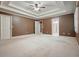 This bedroom includes recessed lighting, crown molding, a ceiling fan and neutral carpeting at 109 Lake Latimer Ne Cv, Kennesaw, GA 30144