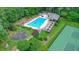 Aerial view showcasing community amenities, including a large pool, seating areas, and tennis courts at 109 Lake Latimer Ne Cv, Kennesaw, GA 30144