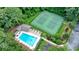 Overhead view highlighting a large community pool and tennis courts surrounded by lush greenery at 109 Lake Latimer Ne Cv, Kennesaw, GA 30144