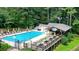 Aerial view of a large community pool with umbrella-covered lounge chairs and a covered eating area at 109 Lake Latimer Ne Cv, Kennesaw, GA 30144