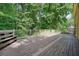 Spacious wood deck with built-in bench and white railings, backing to mature trees at 109 Lake Latimer Ne Cv, Kennesaw, GA 30144