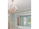 Dining room with wainscoting, chandelier and views to living room and bay window at 109 Lake Latimer Ne Cv, Kennesaw, GA 30144
