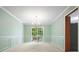 Elegant dining room featuring wainscoting, a chandelier, and a sliding door to the backyard at 109 Lake Latimer Ne Cv, Kennesaw, GA 30144