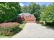 A traditional two-story brick home with a spacious driveway and manicured landscaping at 109 Lake Latimer Ne Cv, Kennesaw, GA 30144