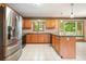 Open kitchen features stainless steel appliances, wood cabinets and backsplash, plus a center island at 109 Lake Latimer Ne Cv, Kennesaw, GA 30144