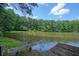 Scenic view of the lake, enhanced by a charming dock and surrounded by beautiful, lush trees at 109 Lake Latimer Ne Cv, Kennesaw, GA 30144