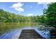 A wooden dock extends onto the lake, with surrounding trees and a serene view at 109 Lake Latimer Ne Cv, Kennesaw, GA 30144