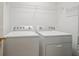 Laundry room with side-by-side washer and dryer units for easy laundry access at 109 Lake Latimer Ne Cv, Kennesaw, GA 30144