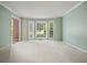 Bright living room featuring a bay window, soft carpeting, and neutral paint at 109 Lake Latimer Ne Cv, Kennesaw, GA 30144