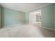 Spacious living room features neutral paint, plush carpeting, and an open doorway to the dining room at 109 Lake Latimer Ne Cv, Kennesaw, GA 30144