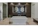 Stunning bathroom showcases a freestanding tub, glass shower, and elegant dark wood cabinetry at 1301 Peachtree Ne St # 4L, Atlanta, GA 30309