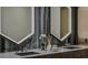 Close-up of bathroom vanity featuring dual sinks, a modern faucet, and decorative accents at 1301 Peachtree Ne St # 4L, Atlanta, GA 30309