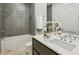 Well-lit bathroom with a soaking tub, modern fixtures, and gray backsplash at 1301 Peachtree Ne St # 4L, Atlanta, GA 30309