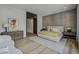 Bright bedroom boasts wood floors, a textured accent wall, and a cozy seating area at 1301 Peachtree Ne St # 4L, Atlanta, GA 30309