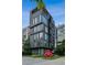 Modern building exterior with striking architecture, multiple floors, and nearby greenery at 1301 Peachtree Ne St # 4L, Atlanta, GA 30309